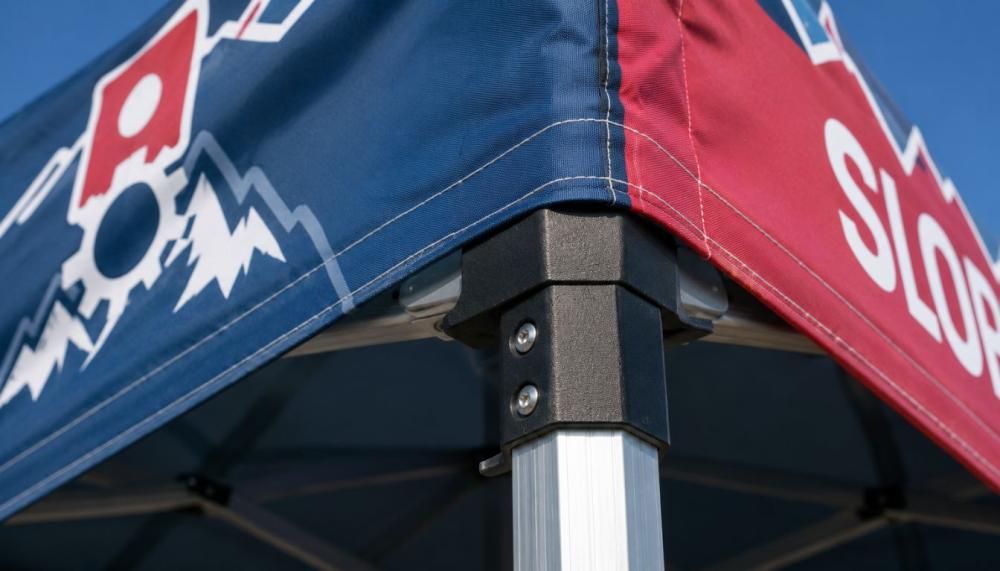 Collapsible 40mm hexagonal aluminum tent frame being packed into a heavy-duty padded