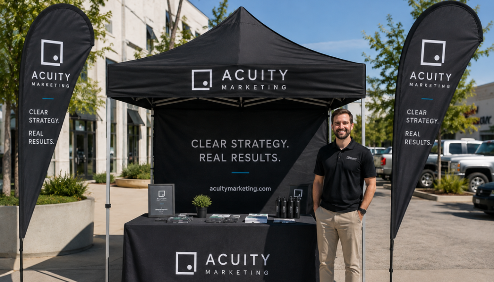 Coordinated custom canopy tent, table cover, and teardrop flags at an event