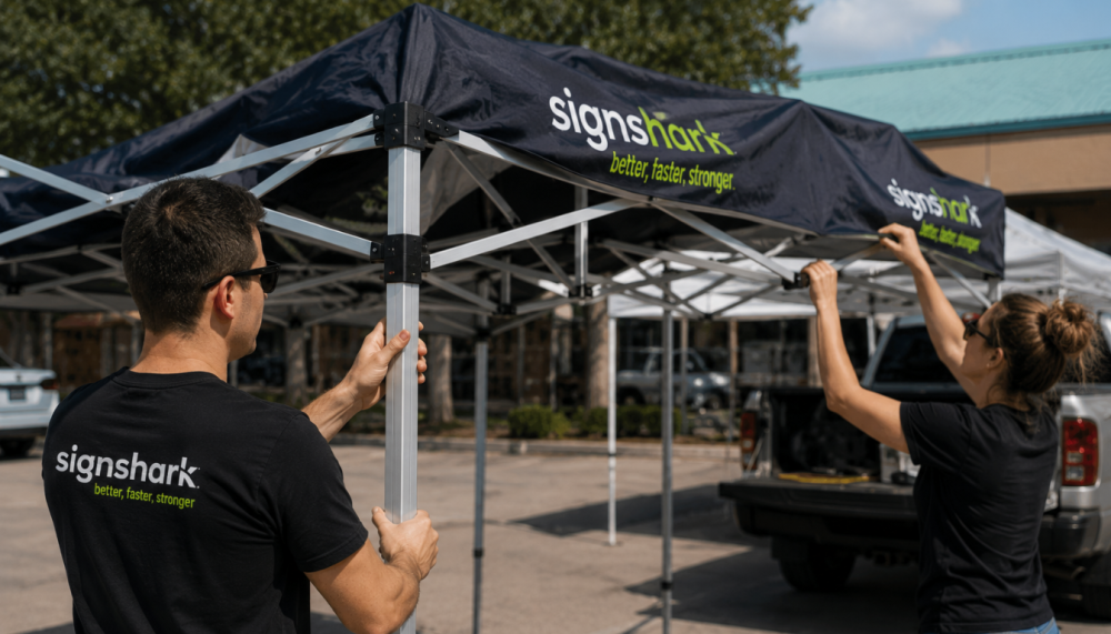 Two people setting up a commercial-grade custom canopy tent frame
